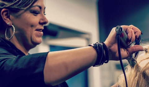 Hairstylist student works with a straightener